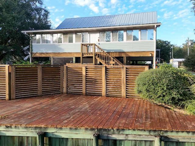 back of house with a deck