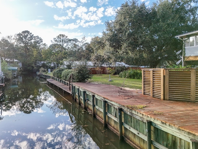 dock area featuring a yard and a water view