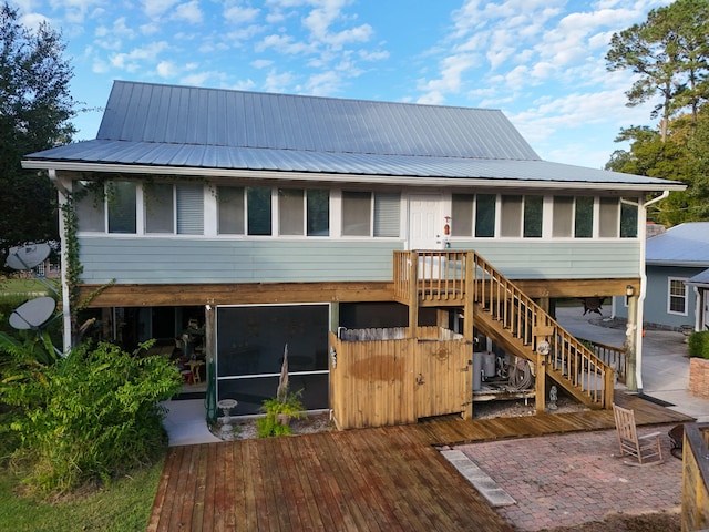 back of property with a patio, a sunroom, and a deck