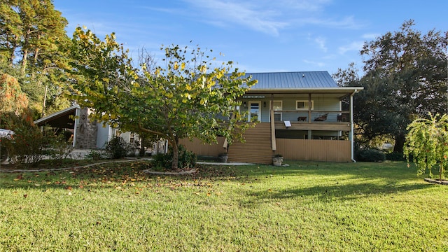 back of property featuring a yard