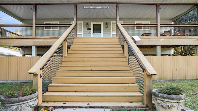 view of exterior entry featuring a deck