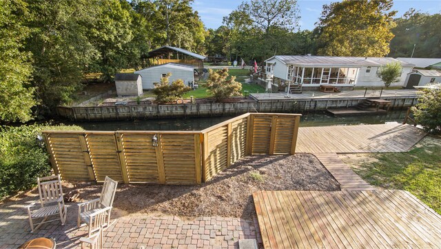 view of patio with a dock and an outdoor structure