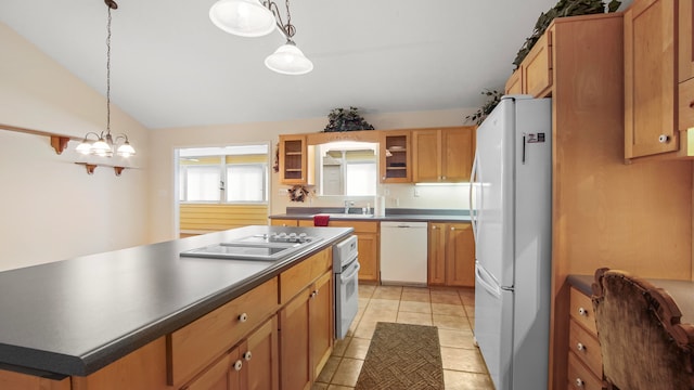 kitchen featuring a kitchen island, light tile patterned floors, hanging light fixtures, vaulted ceiling, and white appliances