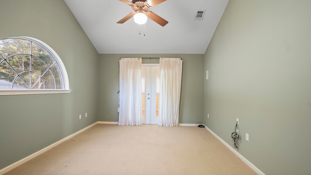 spare room with ceiling fan, vaulted ceiling, and carpet floors