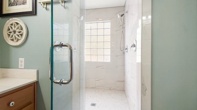 bathroom with walk in shower, tile patterned flooring, plenty of natural light, and vanity