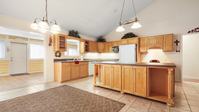 kitchen featuring white refrigerator, lofted ceiling, light tile patterned floors, and a center island