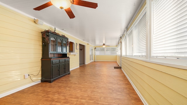 hallway featuring wood walls