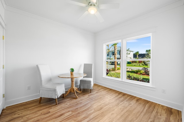 sitting room with light wood-type flooring, a wealth of natural light, and ornamental molding