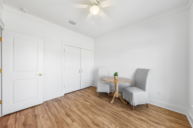 sitting room with ceiling fan, light hardwood / wood-style floors, and ornamental molding