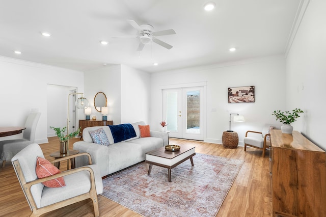 living room with french doors, light hardwood / wood-style flooring, ceiling fan, and crown molding