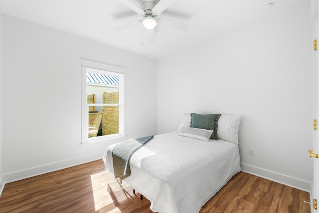 bedroom featuring ceiling fan and dark wood-type flooring