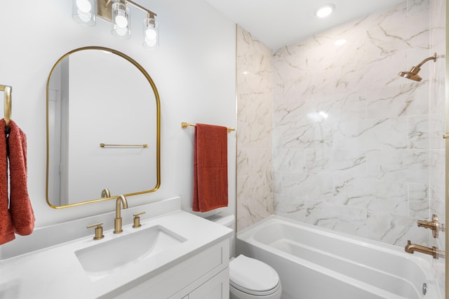 full bathroom featuring vanity, tiled shower / bath combo, and toilet