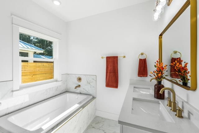 bathroom with vanity and a relaxing tiled tub