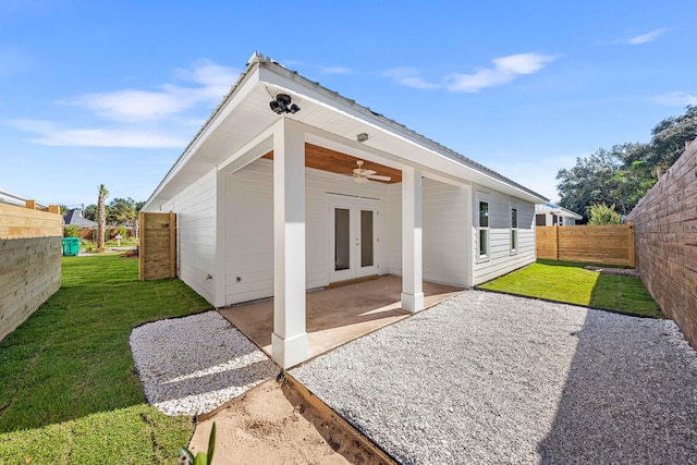 rear view of house with a lawn, a patio area, ceiling fan, and french doors