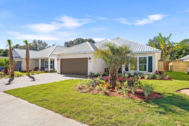 ranch-style house featuring a front yard and a garage