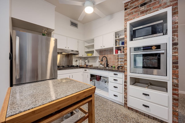 kitchen with white cabinets, backsplash, sink, and stainless steel appliances