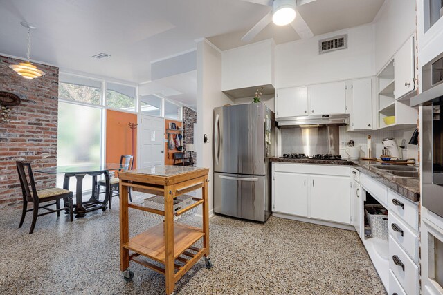 kitchen featuring white cabinets, backsplash, and stainless steel appliances