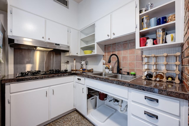 kitchen featuring decorative backsplash, sink, white cabinets, and stainless steel gas cooktop