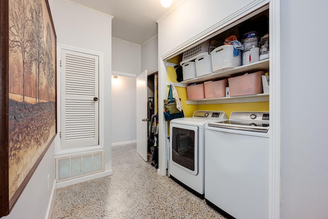 washroom featuring washing machine and clothes dryer and crown molding