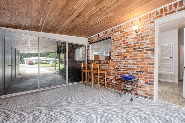 unfurnished sunroom featuring wood ceiling