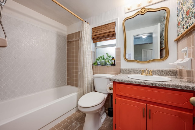 full bathroom with vanity, shower / bath combo, tile patterned flooring, toilet, and tile walls