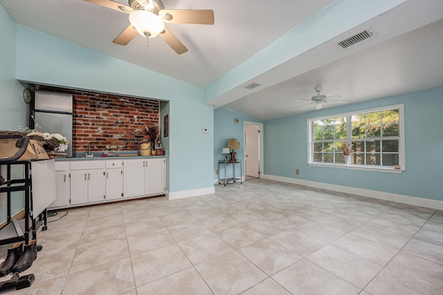 unfurnished living room with lofted ceiling and light tile patterned floors