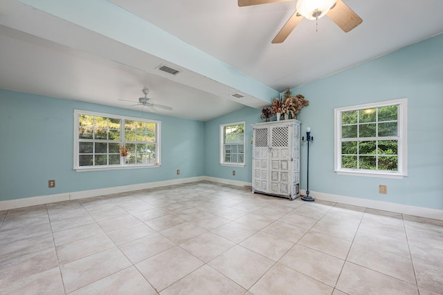 tiled spare room featuring ceiling fan and vaulted ceiling