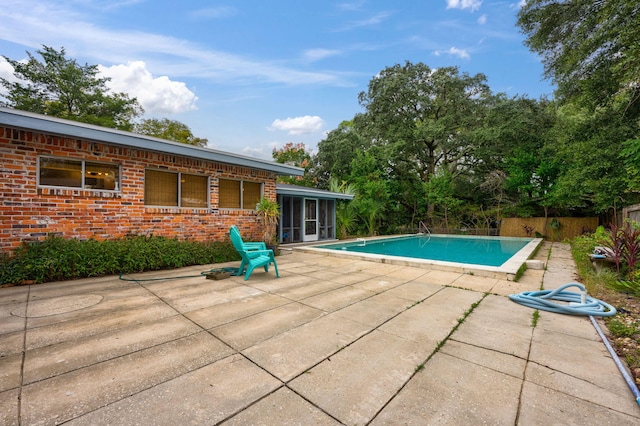 view of swimming pool featuring a patio area