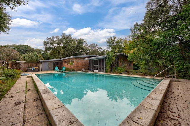 view of pool featuring a sunroom