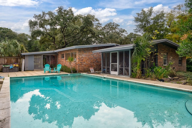 view of pool featuring a sunroom