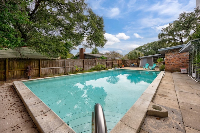 view of swimming pool with a patio