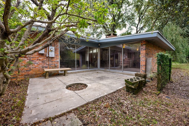 view of patio featuring a sunroom