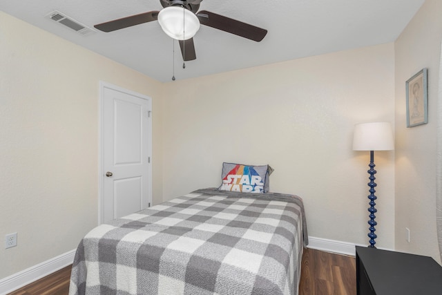 bedroom with ceiling fan and dark hardwood / wood-style floors