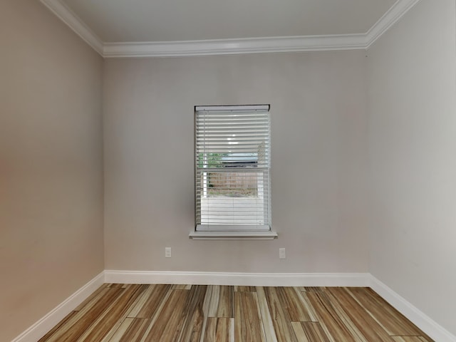 empty room featuring ornamental molding and light wood-type flooring