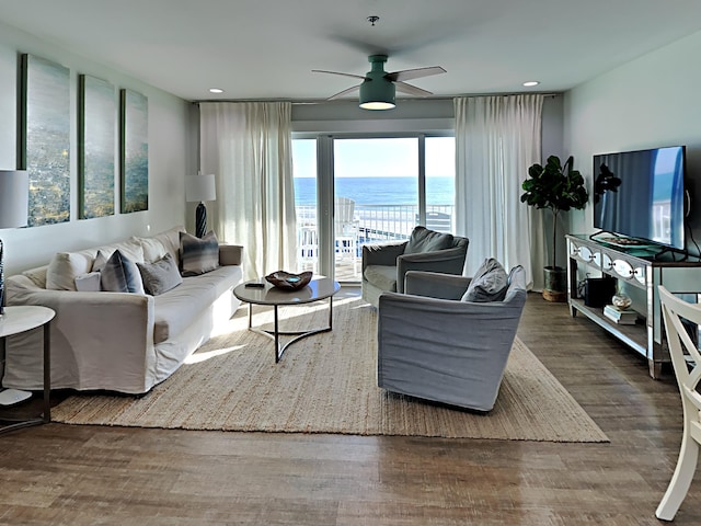 living room with hardwood / wood-style flooring and ceiling fan