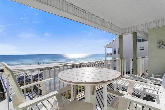 balcony featuring a beach view and a water view