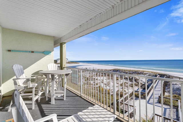 balcony with a view of the beach and a water view