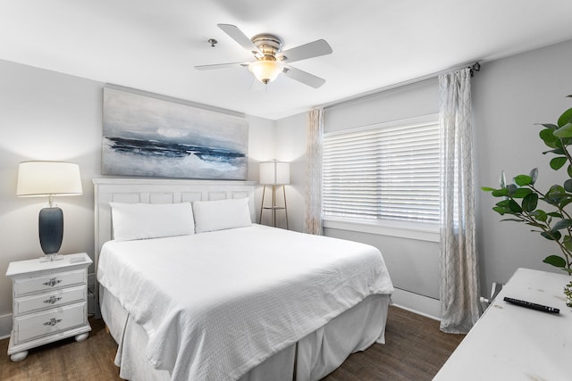 bedroom with dark hardwood / wood-style flooring and ceiling fan