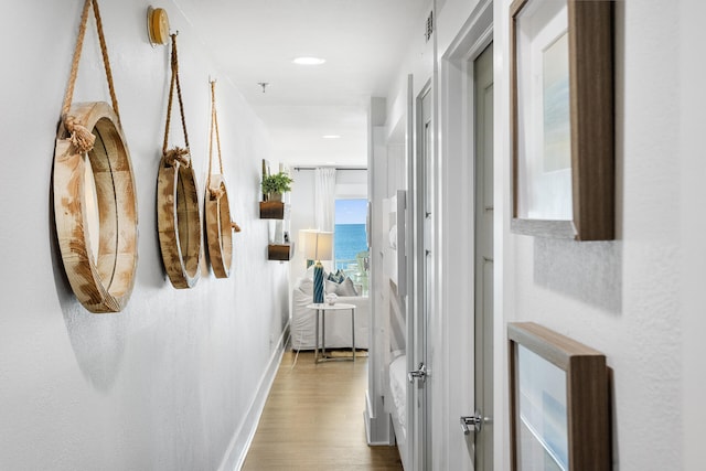 hall featuring hardwood / wood-style floors and a water view