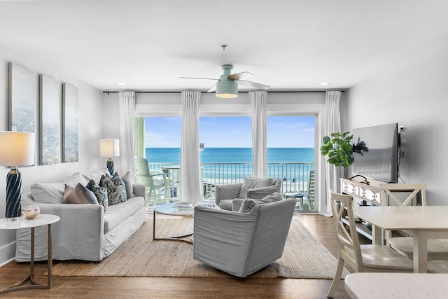 living room featuring ceiling fan, plenty of natural light, and hardwood / wood-style flooring