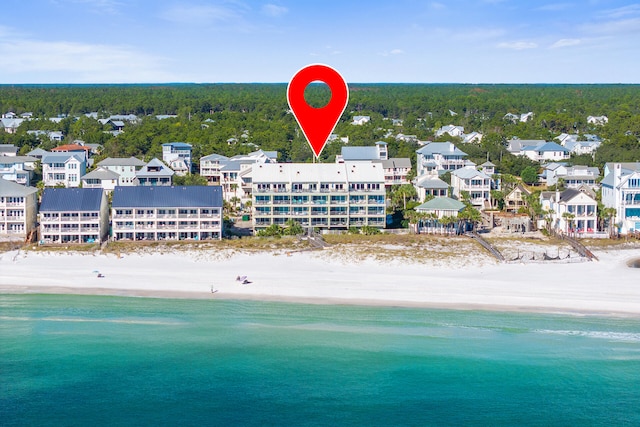 bird's eye view featuring a water view and a view of the beach