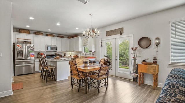 dining space with dark wood-type flooring, recessed lighting, french doors, and baseboards