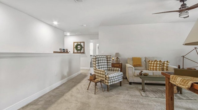 living area with a ceiling fan, recessed lighting, light colored carpet, and baseboards