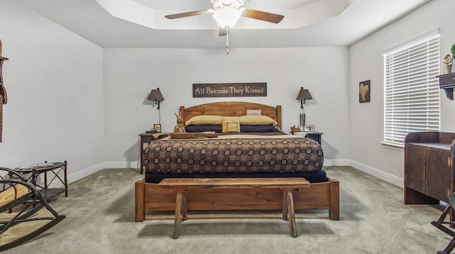 bedroom featuring baseboards, a ceiling fan, and light colored carpet