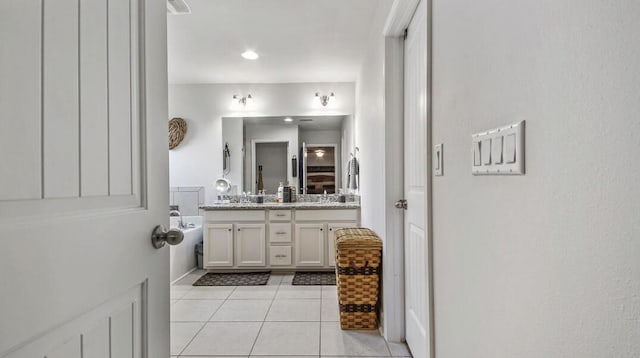 bathroom featuring double vanity, visible vents, and tile patterned floors