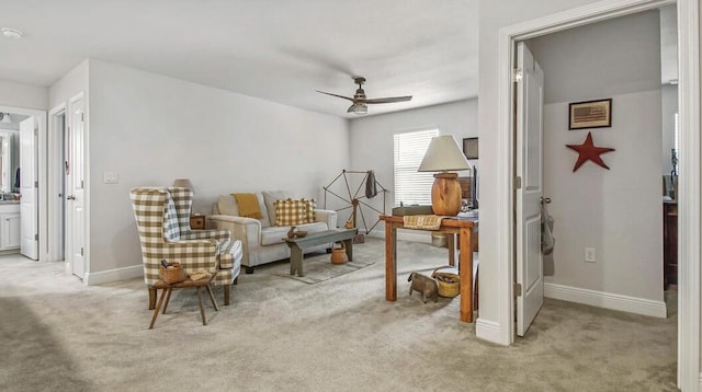 sitting room featuring light carpet, ceiling fan, and baseboards