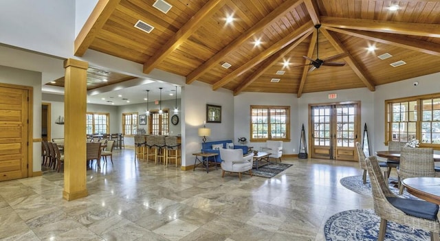 living room featuring high vaulted ceiling, a wealth of natural light, visible vents, and ornate columns