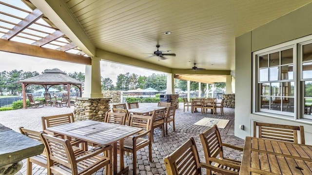 view of patio / terrace with ceiling fan, a gazebo, and outdoor dining area