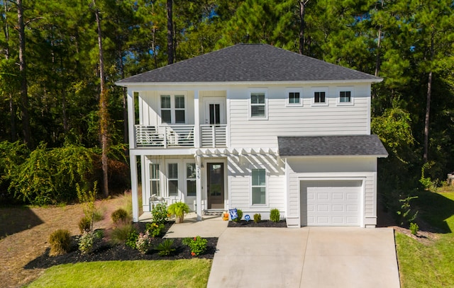 view of front of house featuring a garage and a balcony