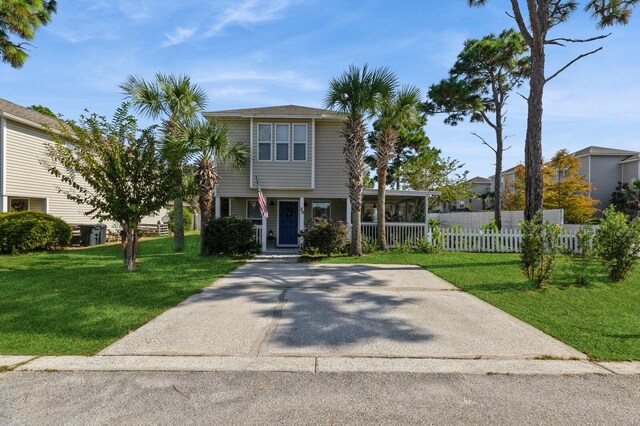 view of front of home with a carport and a front lawn